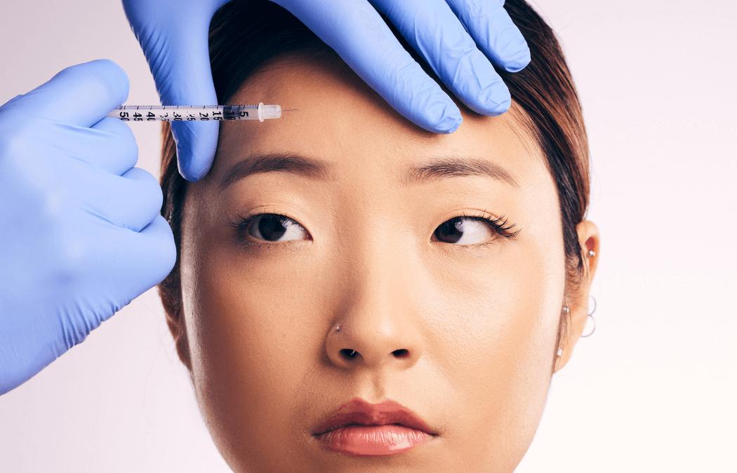 Botox injection to woman's forehead